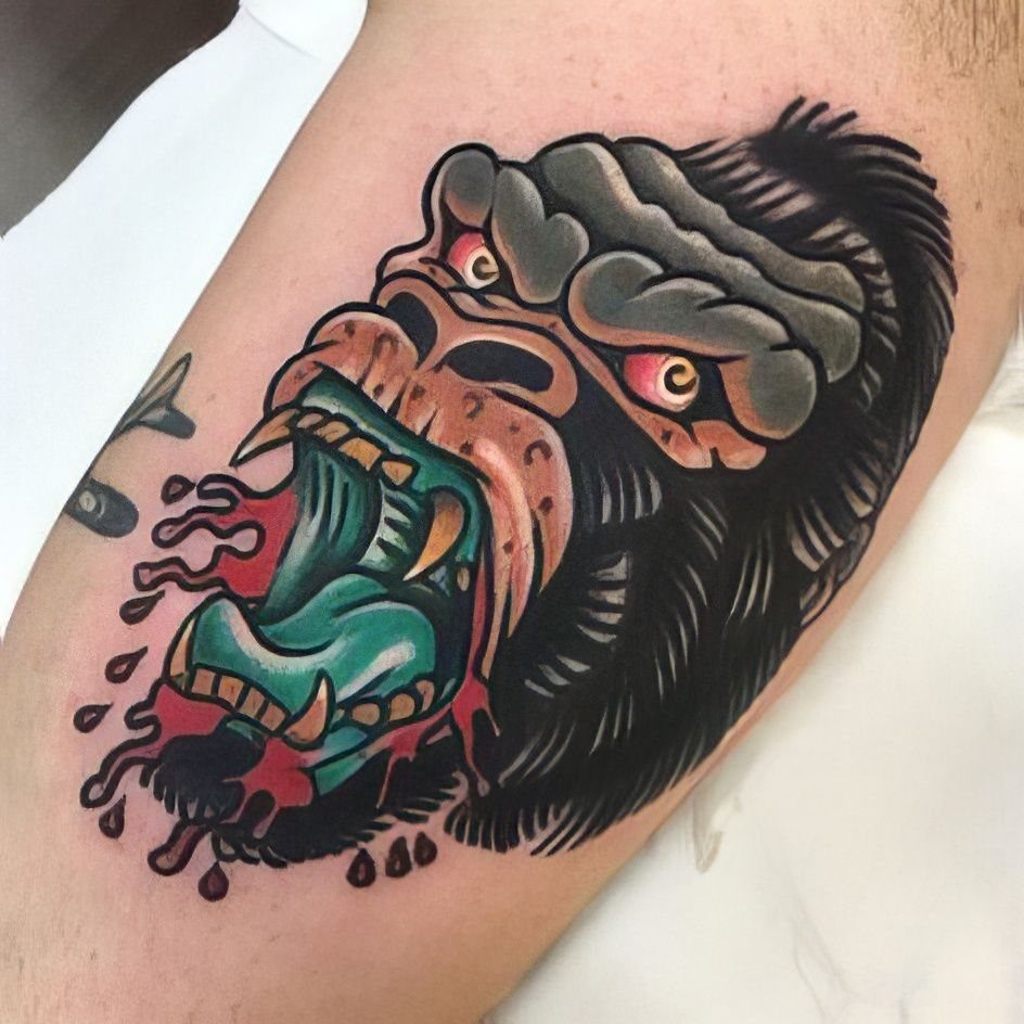 American traditional tattoo of a roaring gorilla head on a person's arm