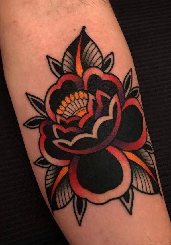 American traditional rose tattoo with bold black outlines and red shading on skin