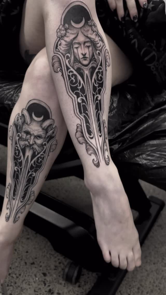 Illustrative black ink tattoos of faces and ornate scrollwork on lower legs