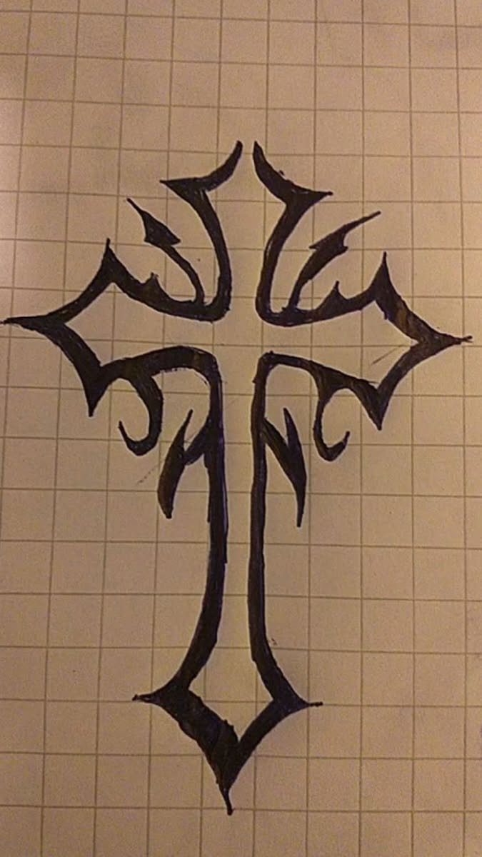 Stylized tribal cross design drawn with black ink on white grid paper.