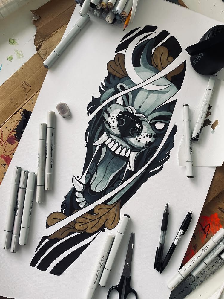 Detailed drawing of a snarling animal head surrounded by markers on white paper.