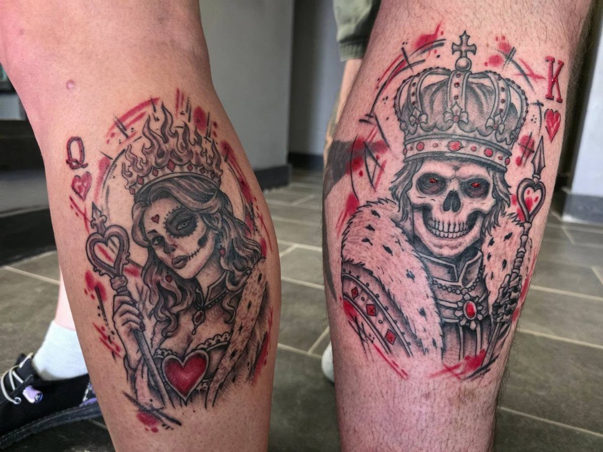 Matching sugar skull king and queen tattoos on two people's lower legs.