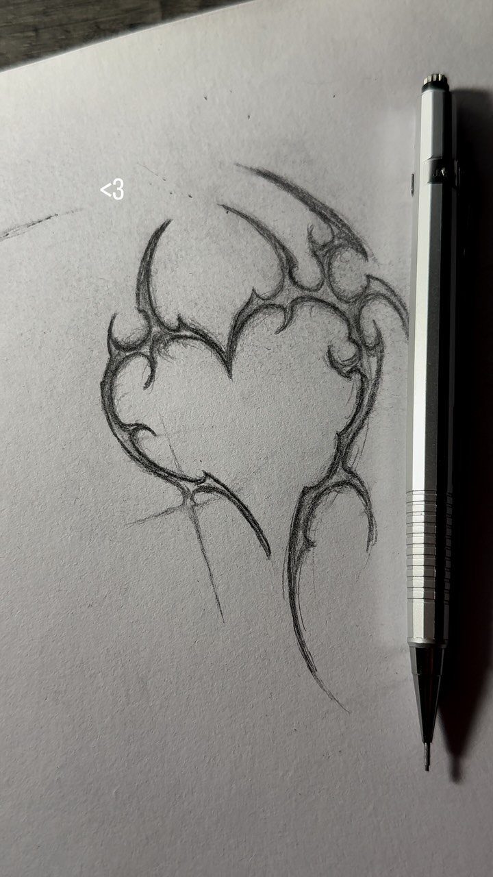 Tribal heart pencil drawing on white paper with a silver mechanical pencil beside it.