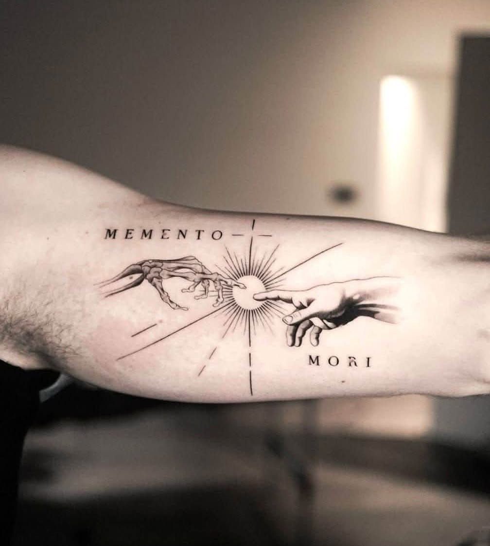 Forearm tattoo with line work showing a skeletal and human hand reaching together.