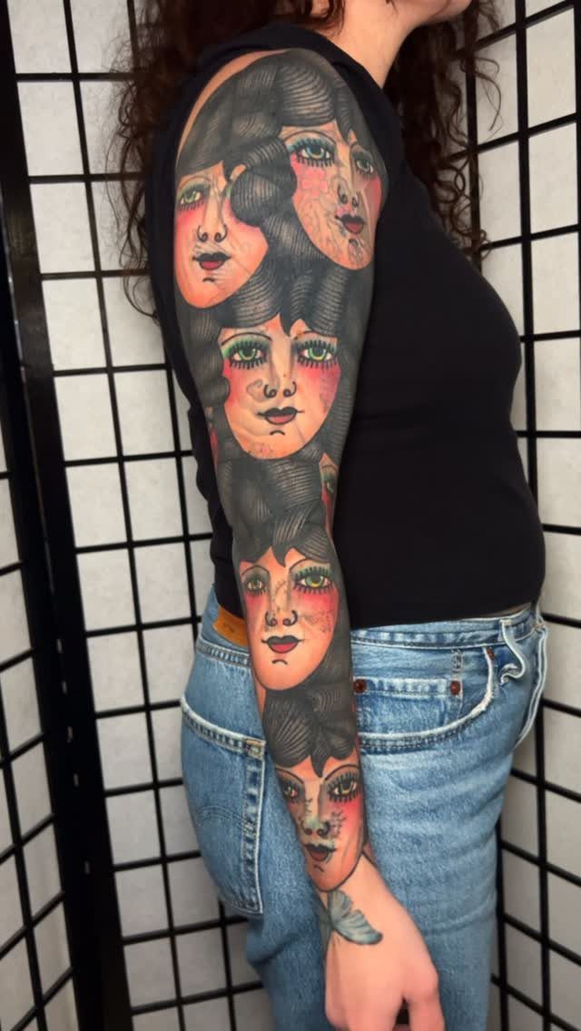 Full sleeve tattoo of multiple overlapping female faces on a person's arm.