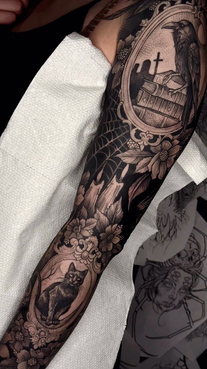 Black and grey tattoo sleeve featuring a black cat and a crow.