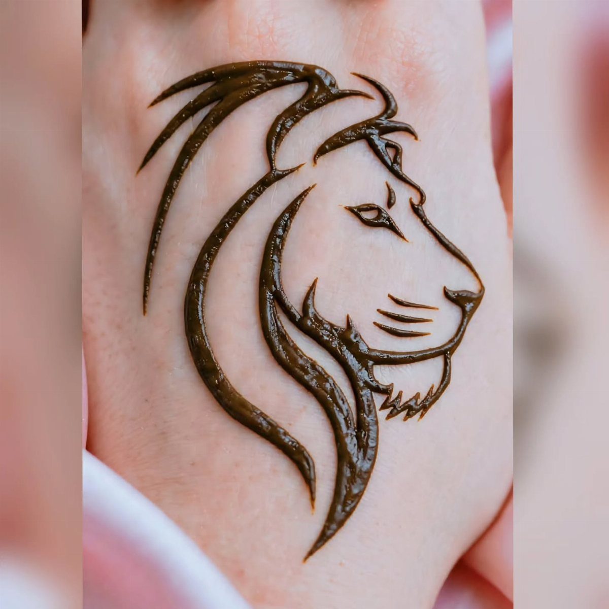 Lion head henna tattoo with raised brown paste creating a 3D effect on skin