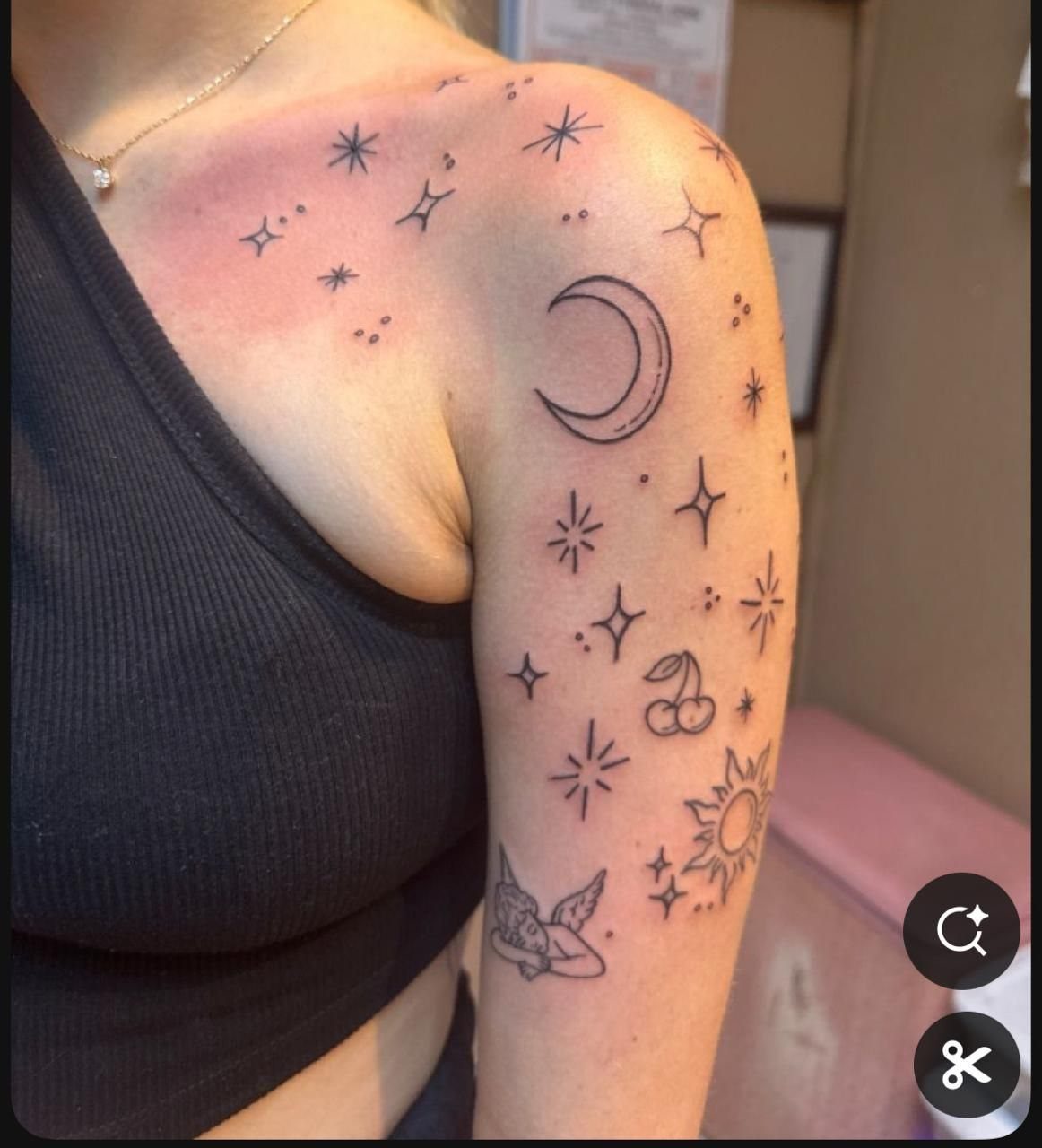 Crescent moon and stars tattoos on a person's shoulder and upper arm.