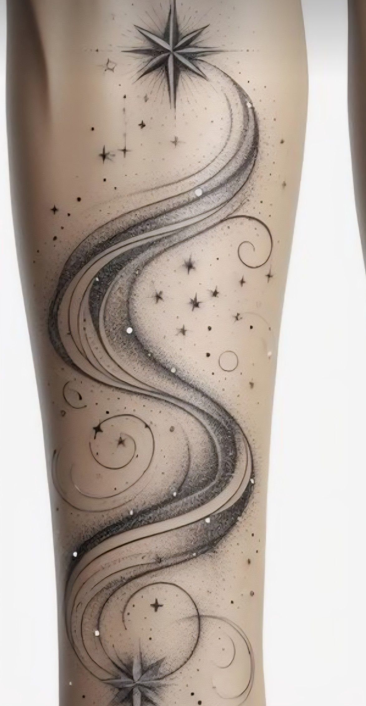 Tattoo on an arm showing a star with swirling trailing lines and small stars.