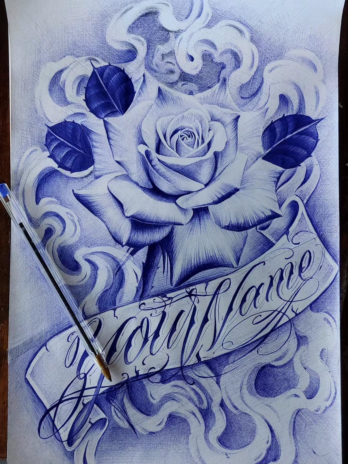 Blue ink drawing of a rose with swirling clouds and a name banner.