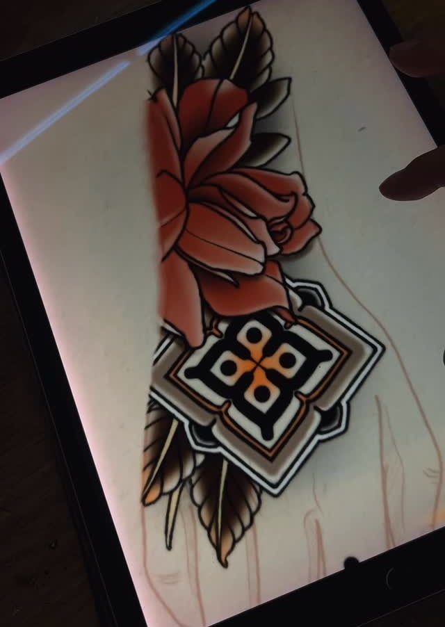 Red rose tattoo design with a geometric ornament on a digital tablet screen