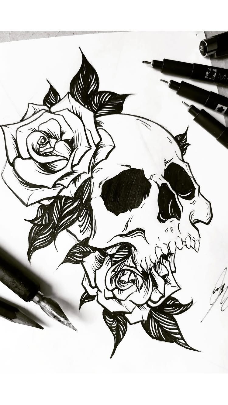 Skull and rose tattoo design drawn in black ink on white paper