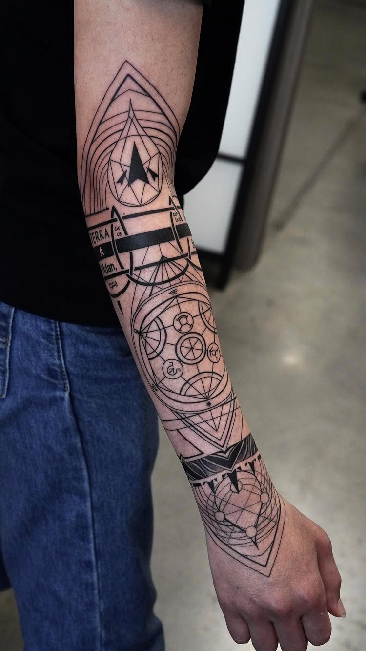 Forearm tattoo with abstract geometric lines, circles, and bold black shapes.