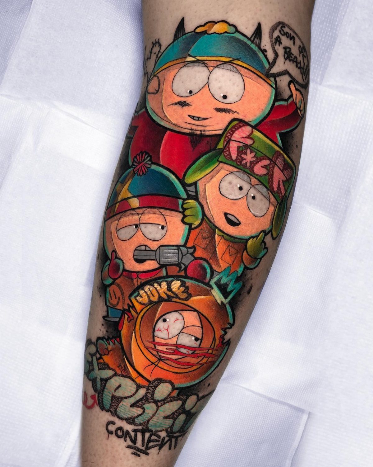South Park cartoon character tattoos with white borders and bold outlines on an arm